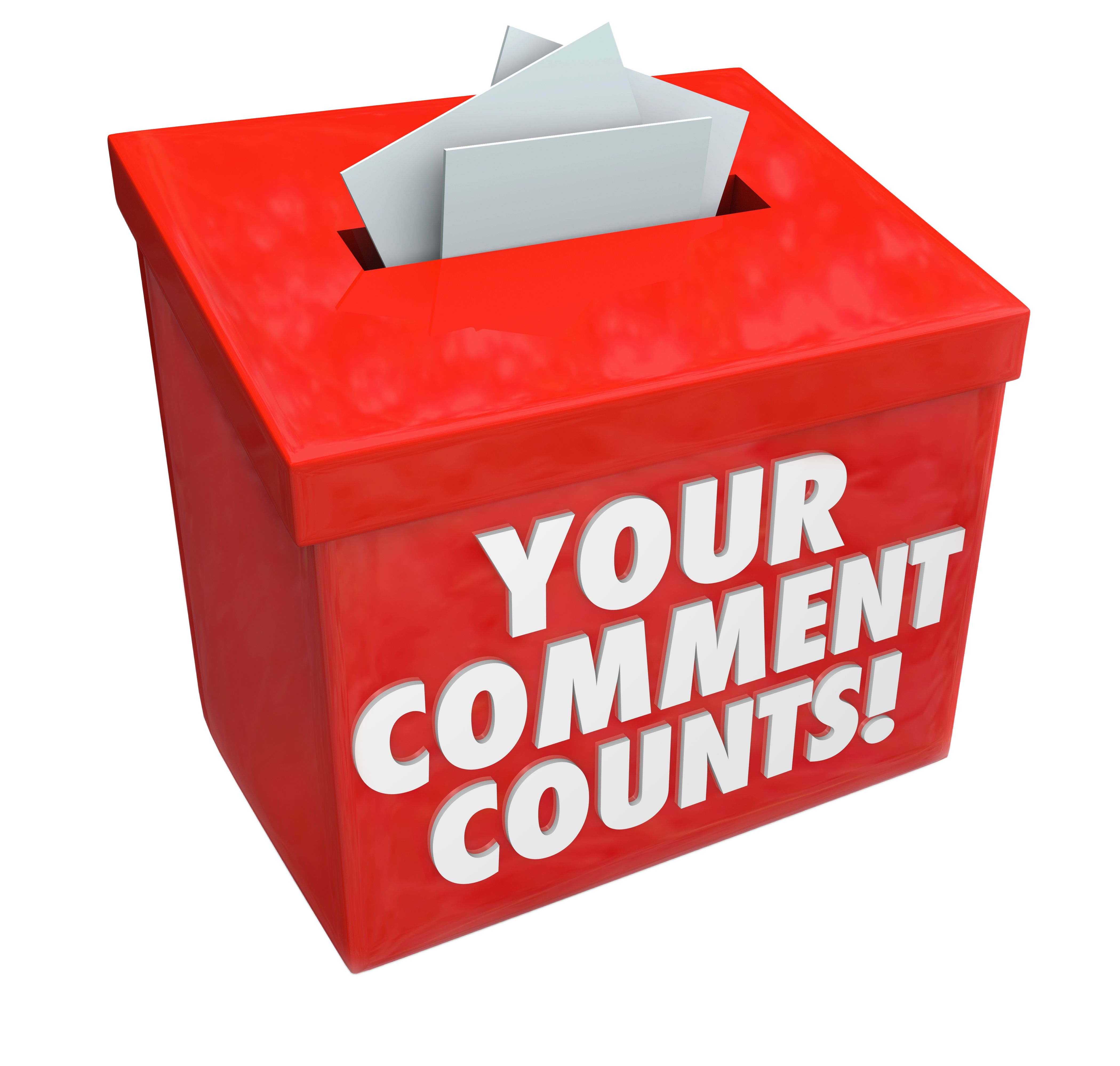 A red ballot box with 'You comment counts' written on the front of the box and the slot on the lid of the box showing some papers being dropped inside